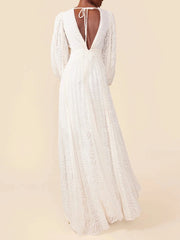 White lace dress with long sleeves on a beige background