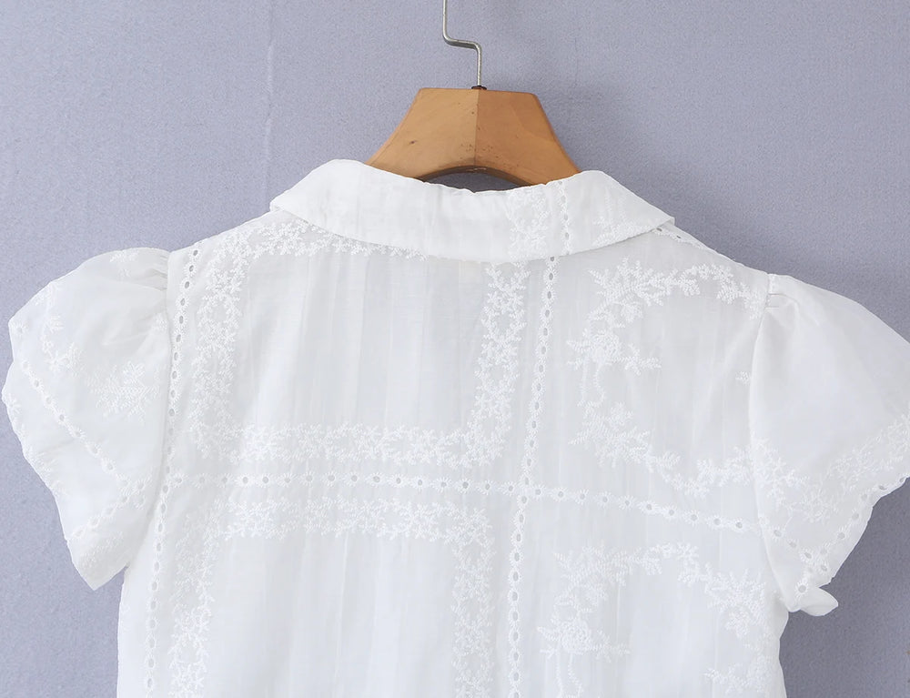 Back detail of white embroidered puff sleeve crop top