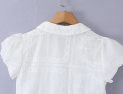 Back detail of white embroidered puff sleeve crop top