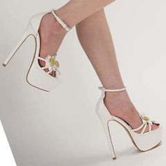 White high-heeled shoes with floral details