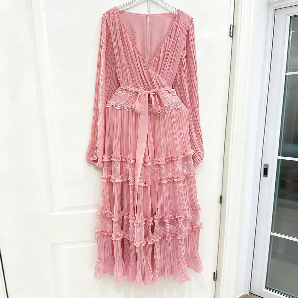 Pink lace dress hanging on a white door