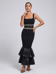 Back view of a black square neck midi dress with a ruffled hem.