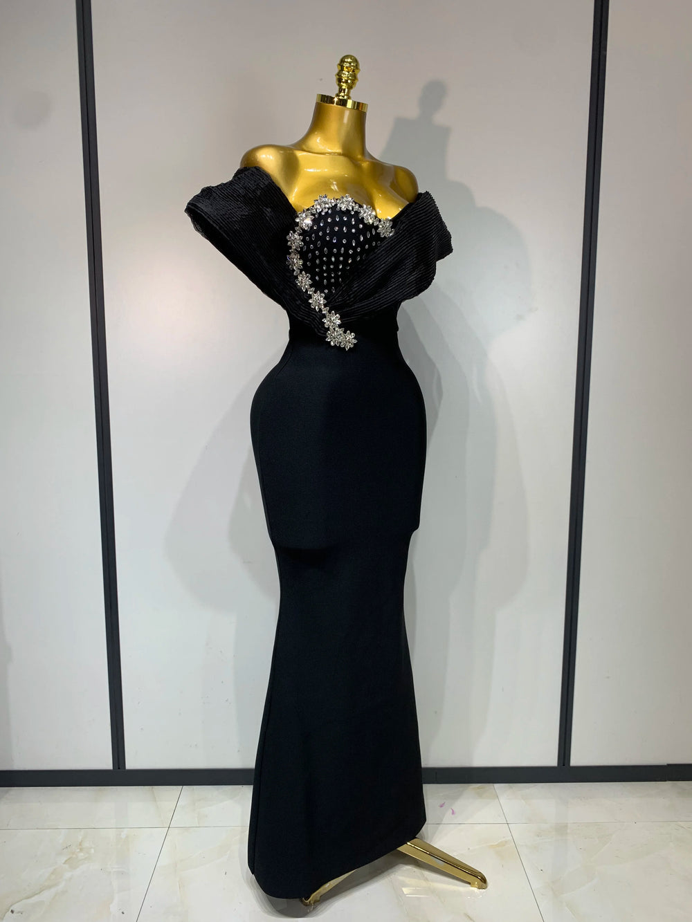 Close-up of the embellished neckline on a black gown