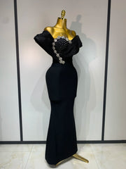 Close-up of the embellished neckline on a black gown