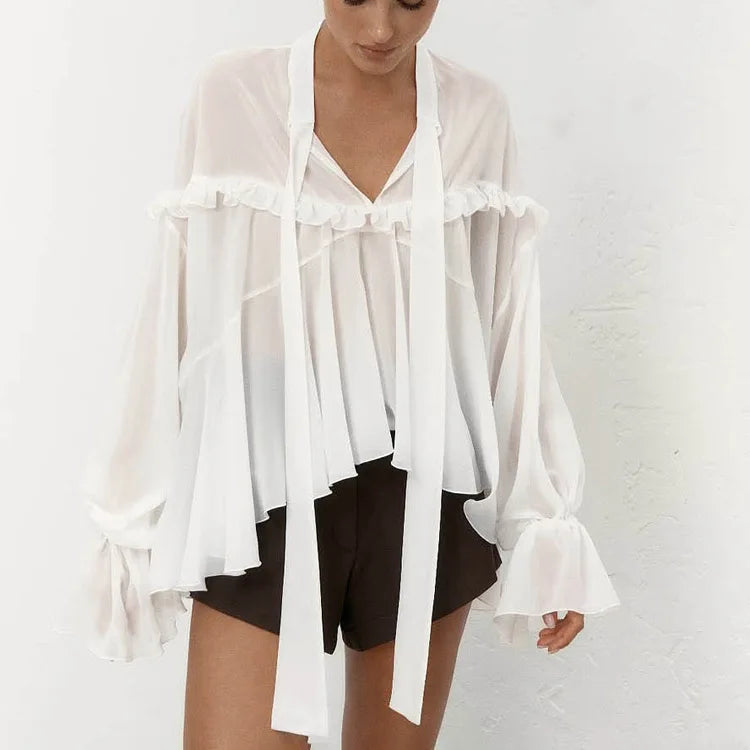 White V-neck flounce blouse styled with black shorts