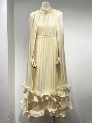 Mannequin wearing a cream-colored dress with ruffled skirt against a gray background