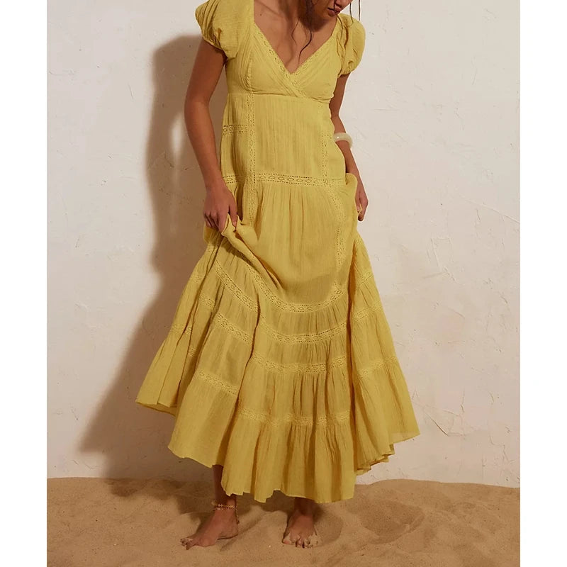 Yellow puff sleeve V-neck maxi dress with lace details.