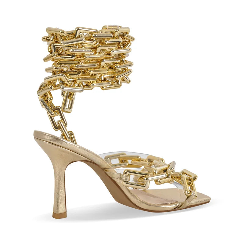 Side view of gold chain ankle-wrap stiletto sandals