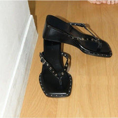 Studded wedge square toe thong sandals on wooden floor