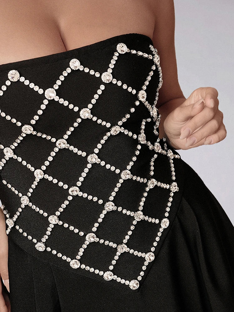 Black strapless dress with a lattice pattern of pearls on a plain background