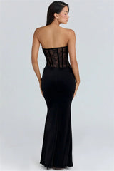 Black strapless gown with sheer back on a white background