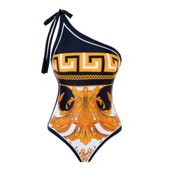 Close-up of a one-piece swimsuit featuring a Greek key and medallion print.