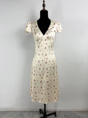 Floral dress on a mannequin against a plain background