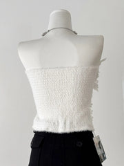 White textured top on a mannequin with a gray background