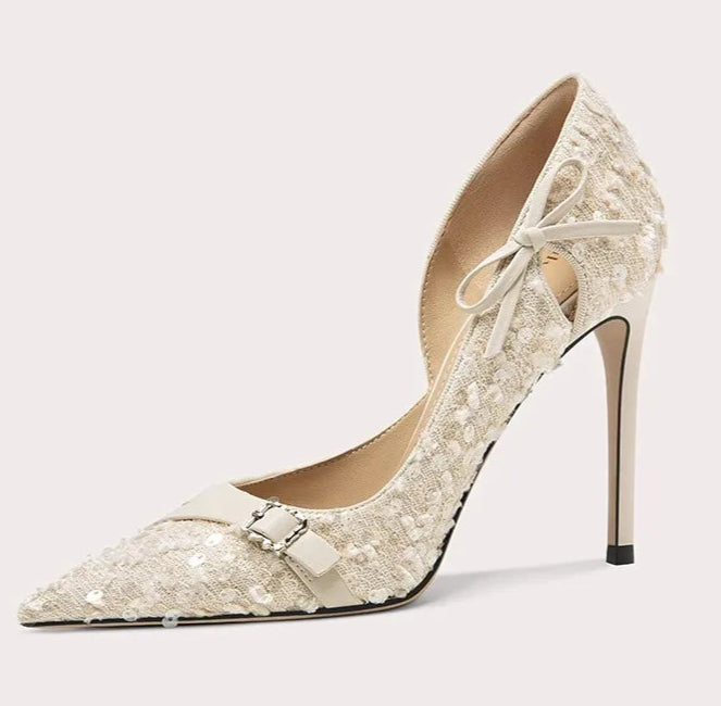 High-heeled shoe with lace design on a light gray background