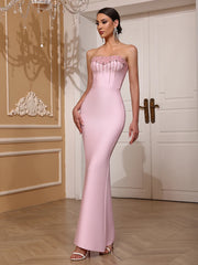 Woman wearing a pink strapless gown in an elegant interior setting