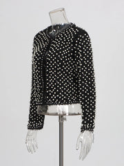 Black jacket with white polka dots on a mannequin against a white background