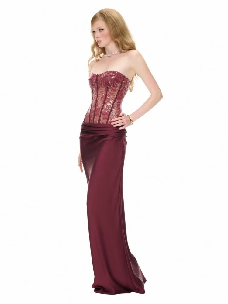 Burgundy sequin strapless corset maxi dress on a model