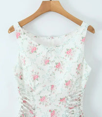 Floral dress on a wooden hanger against a white background