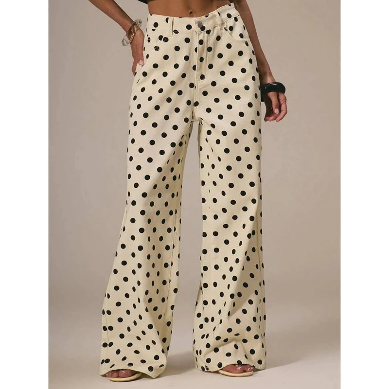 Polka dot pants worn by a person on a beige background