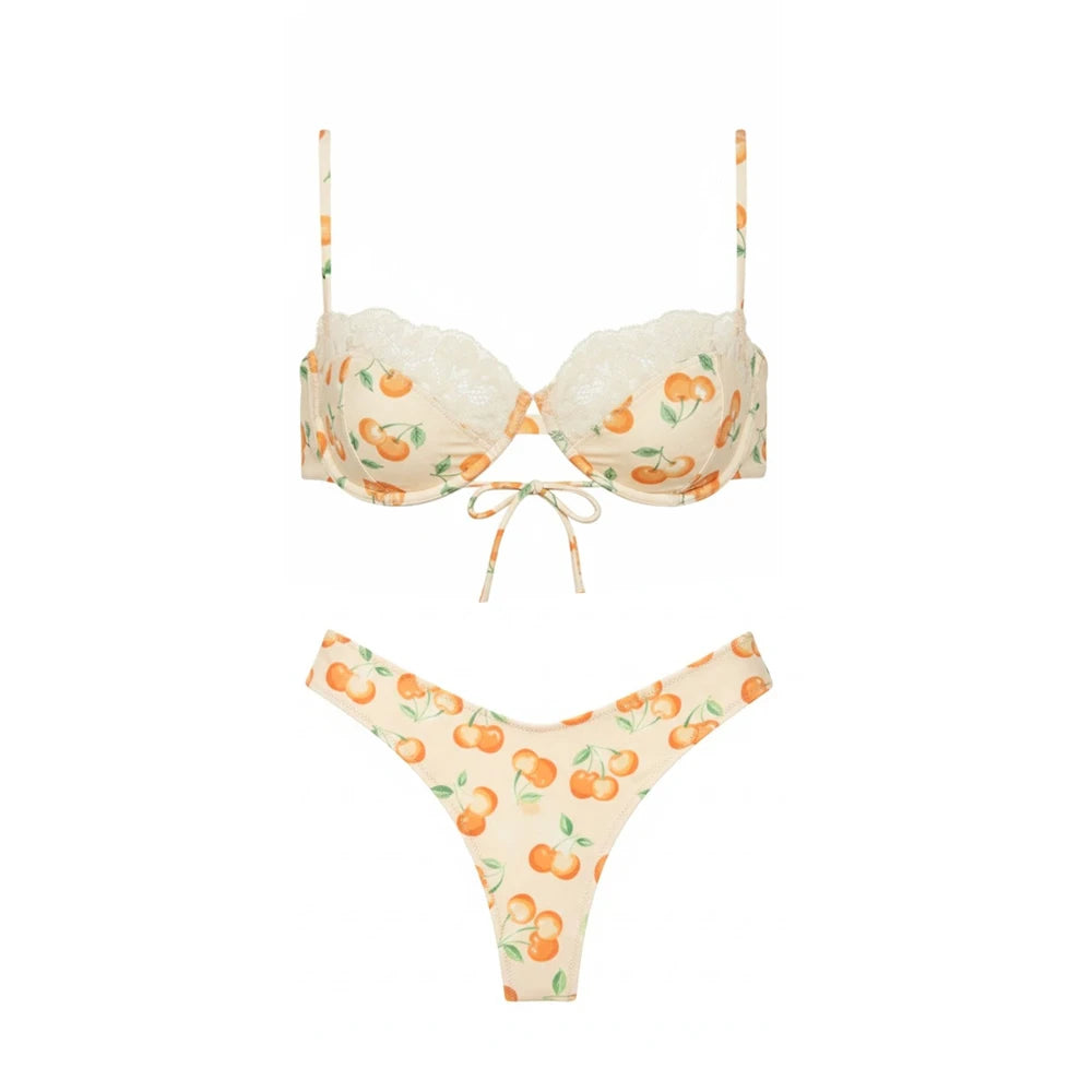 Underwire bikini top and bikini bottoms with cherry print and lace trim.