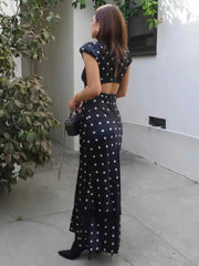 Model wearing polka dot cap sleeve maxi dress outdoors