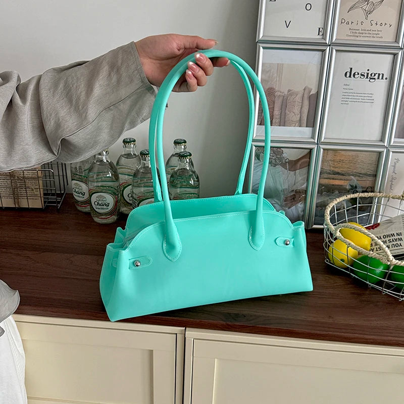 Teal short handle tote bag with zipper closure.