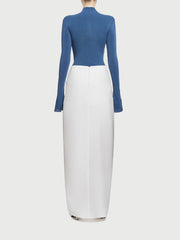 Blue top and white skirt set on a light gray background