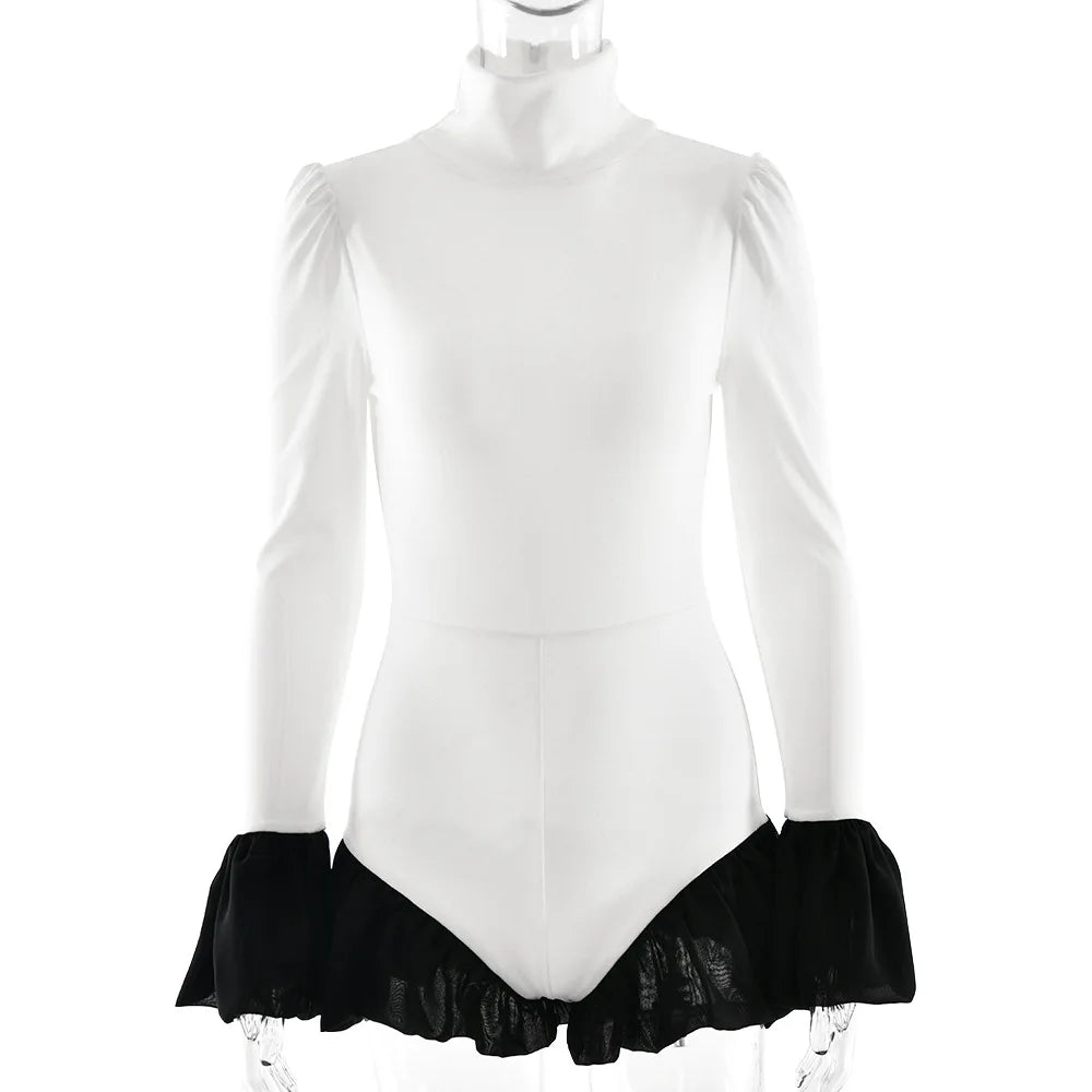 White long-sleeve leotard with black ruffled bottom on a mannequin against a white background
