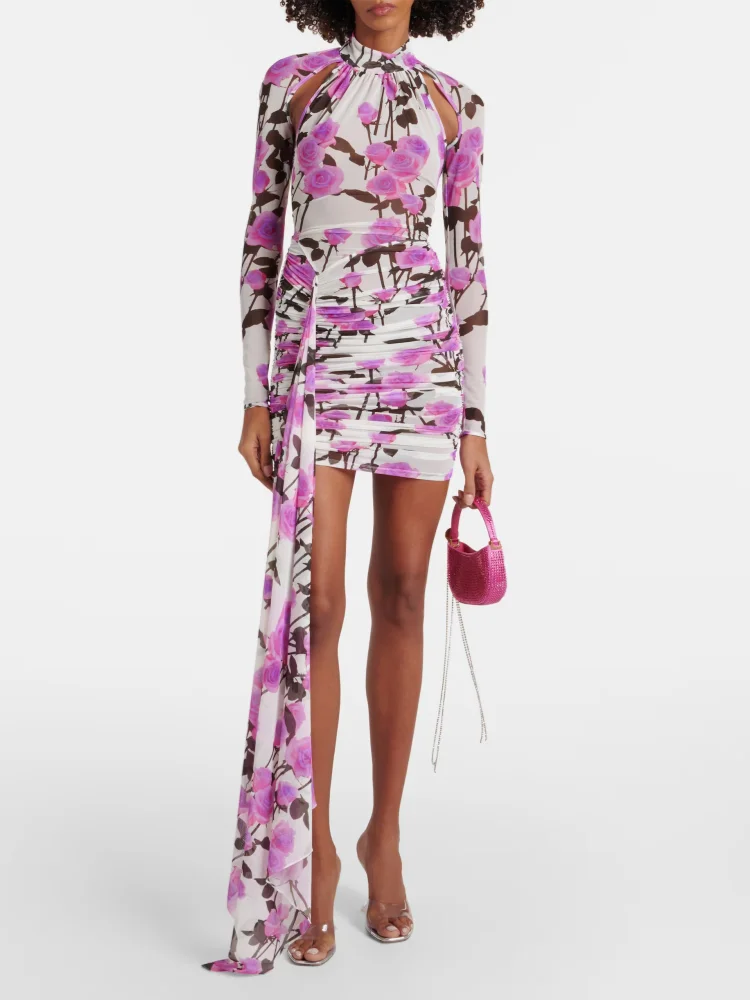 Woman wearing a floral dress with a long train on a white background