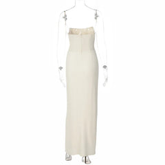 White strapless evening gown with pearl embellishments on a mannequin against a white background