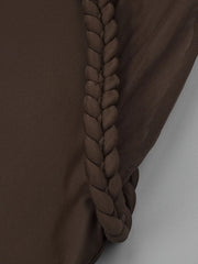Brown fabric with a braided detail on a plain background