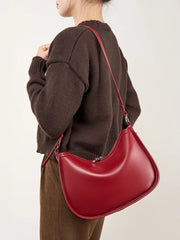 Woman wearing a red leather hobo bag