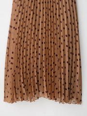 Brown pleated skirt with black polka dots on a white background