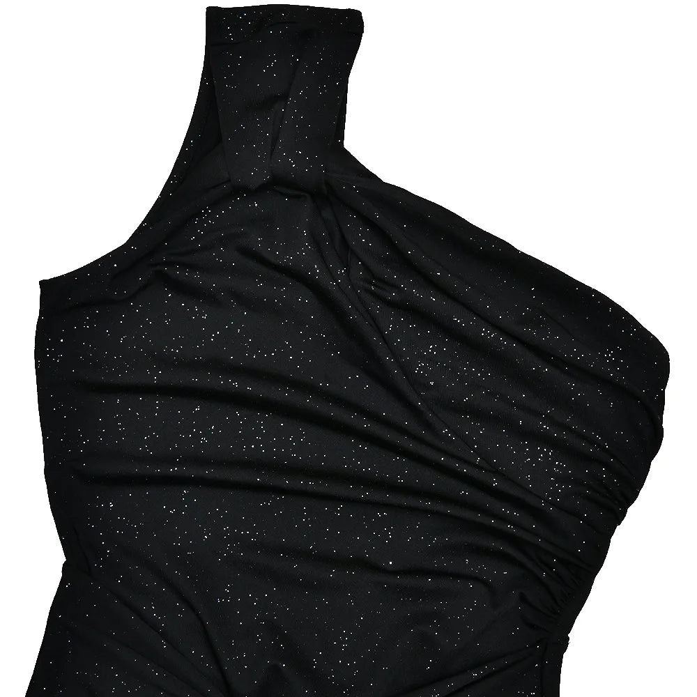 Black one-shoulder dress with glittery texture on a white background