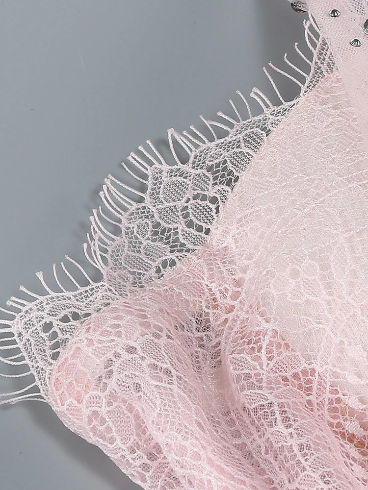 Close-up of pink lace fabric with a gray background