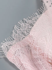 Close-up of pink lace fabric with a gray background