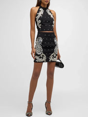 Beaded paisley halter neck crop top and mini skirt on model