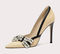 High-heeled shoe with decorative strap on a light gray background