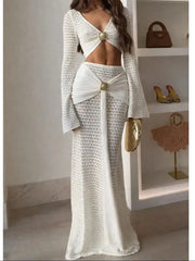 White knit cropped long sleeve top with a matching white knit maxi skirt featuring a draped fabric detail at the waist.