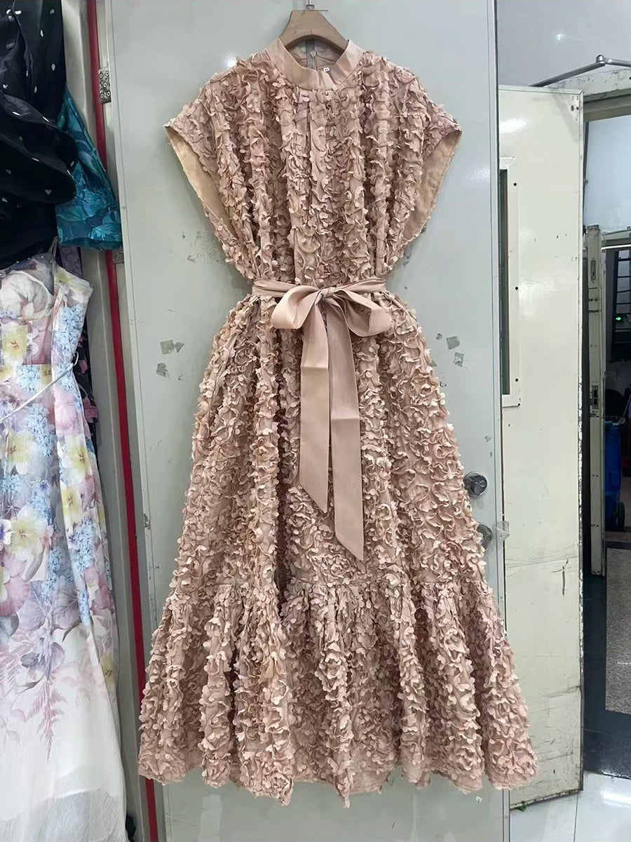 Beige floral dress with a belt hanging on a mirror