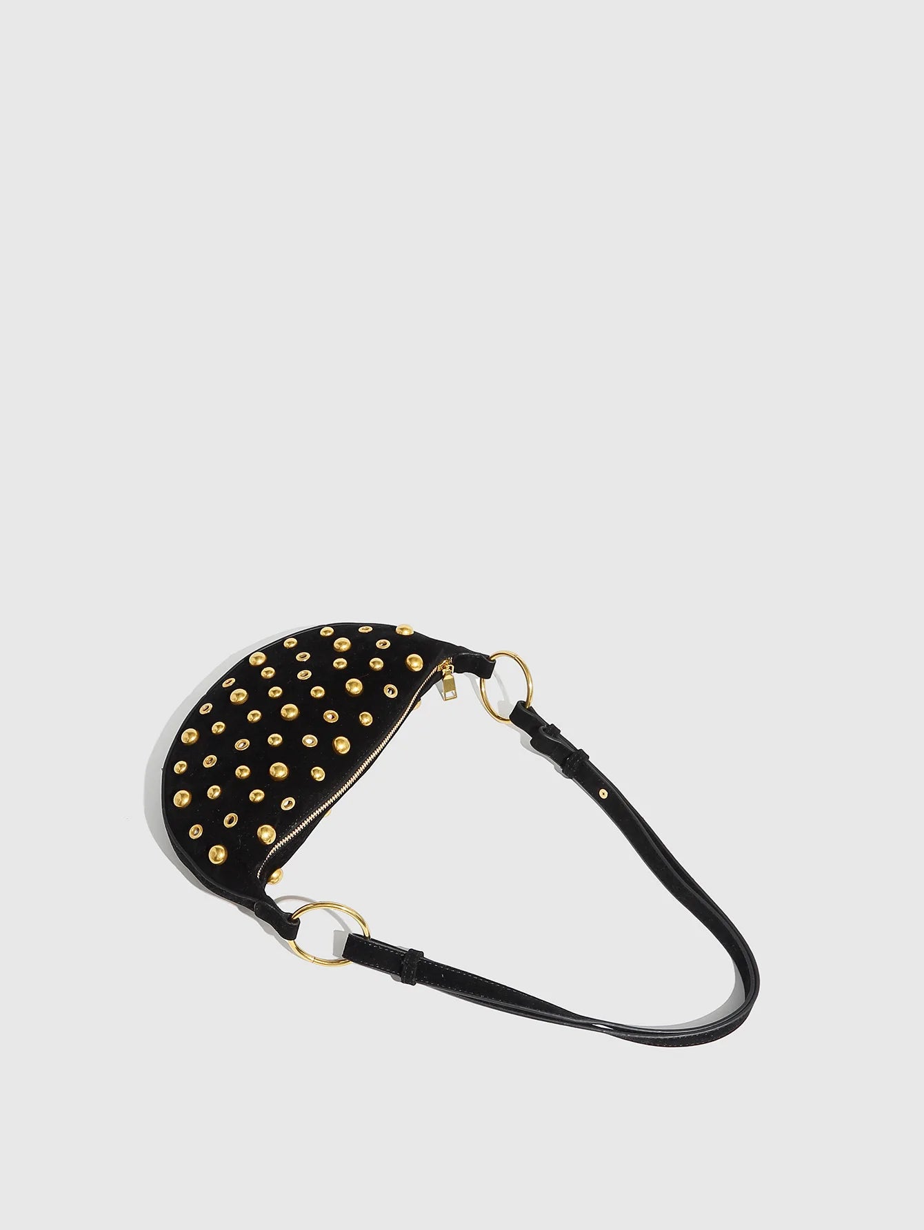Black studded belt bag on a light gray background