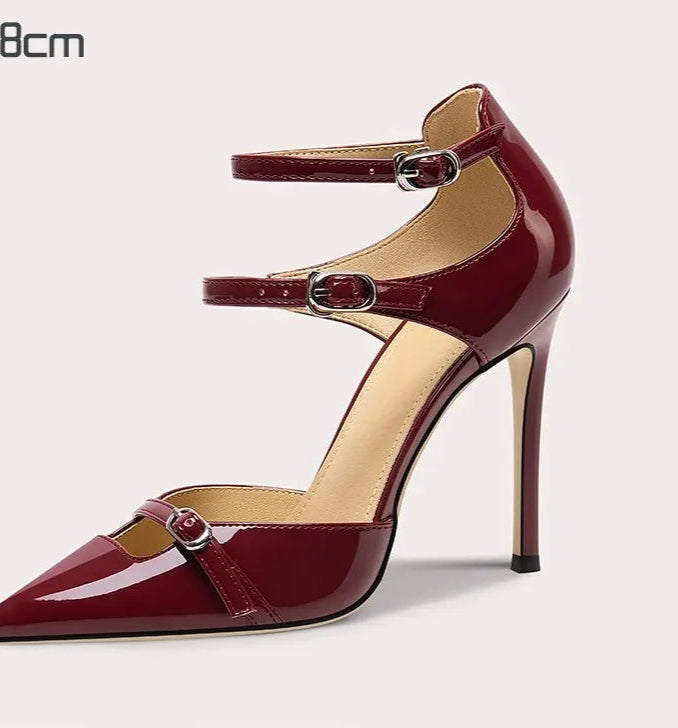 Red high-heeled shoe with a strap on a white background