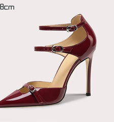 Red high-heeled shoe with a strap on a white background