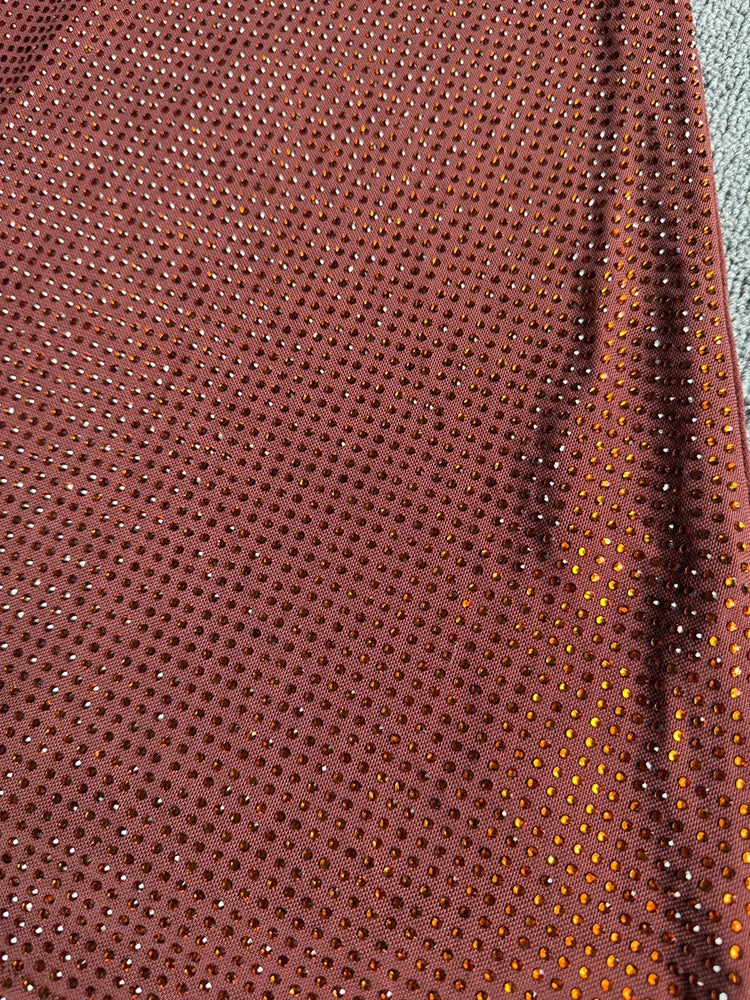 Close-up detail of the sequin embellishments on a floor-length dress.