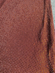 Close-up detail of the sequin embellishments on a floor-length dress.