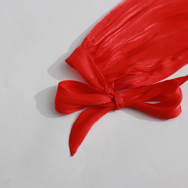 Red fabric with a bow on a light gray background