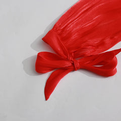 Red fabric with a bow on a light gray background