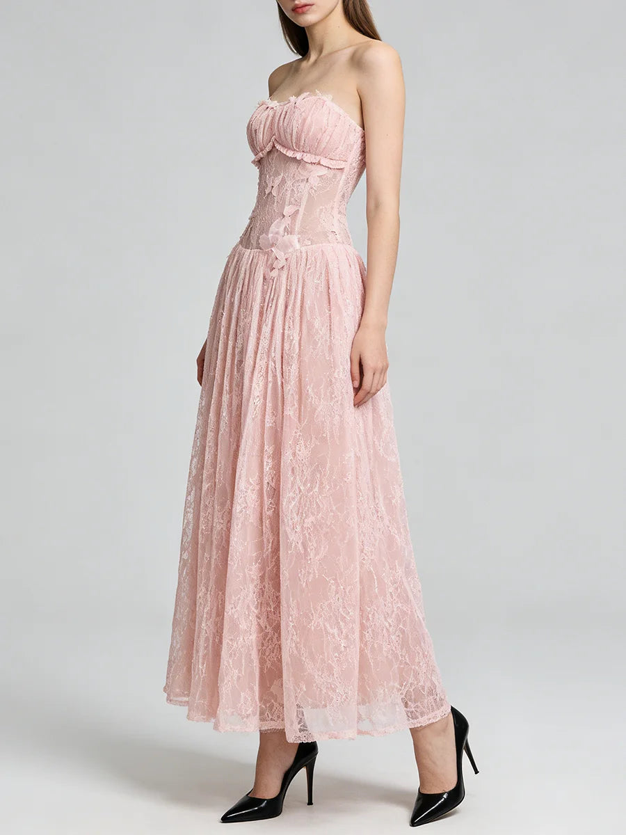 Woman wearing a pink strapless lace dress on a white background
