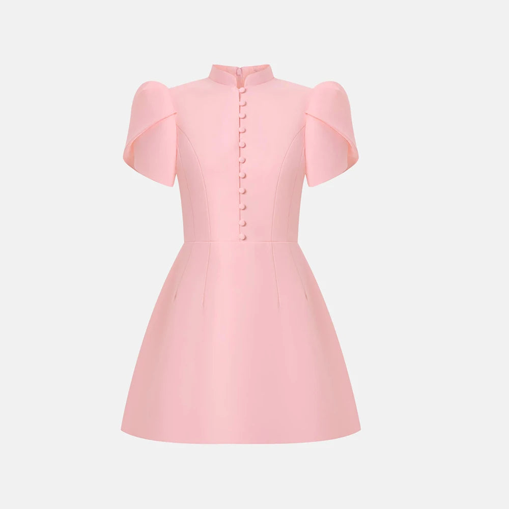 Pink dress with ruffled sleeves on a light gray background